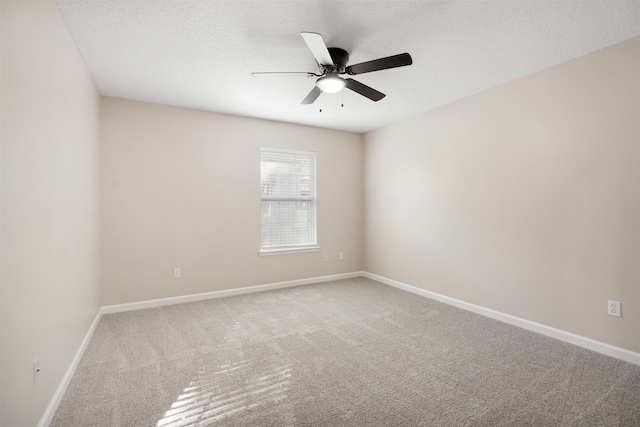 spare room featuring carpet, ceiling fan, and a textured ceiling