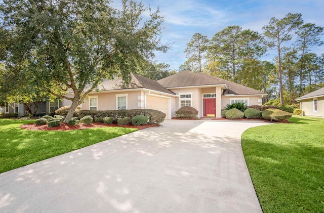 view of front of house featuring a garage and a front lawn