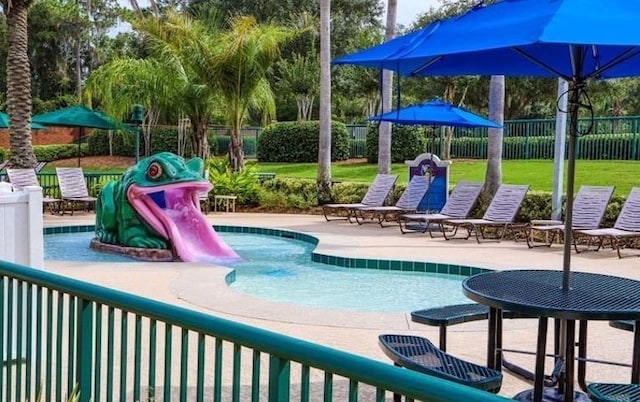 view of pool featuring a lawn and a patio