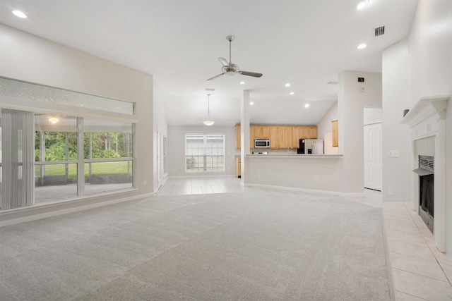 unfurnished living room featuring ceiling fan, high vaulted ceiling, and light colored carpet