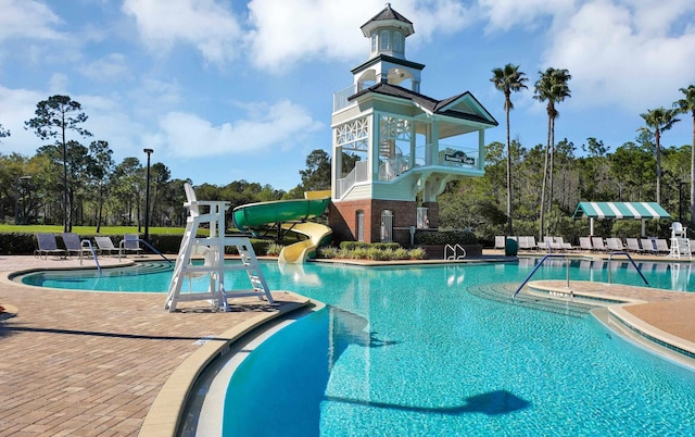 view of pool featuring a patio and a water slide