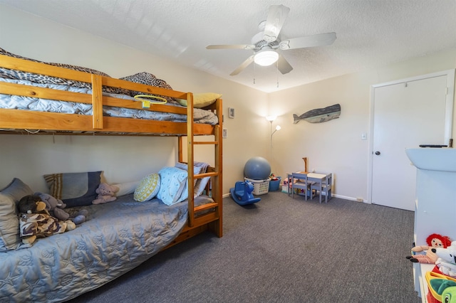 carpeted bedroom with ceiling fan and a textured ceiling