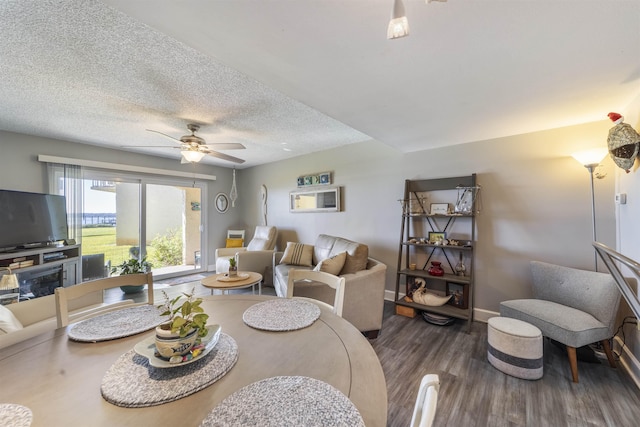 dining space featuring ceiling fan, dark hardwood / wood-style floors, and a textured ceiling