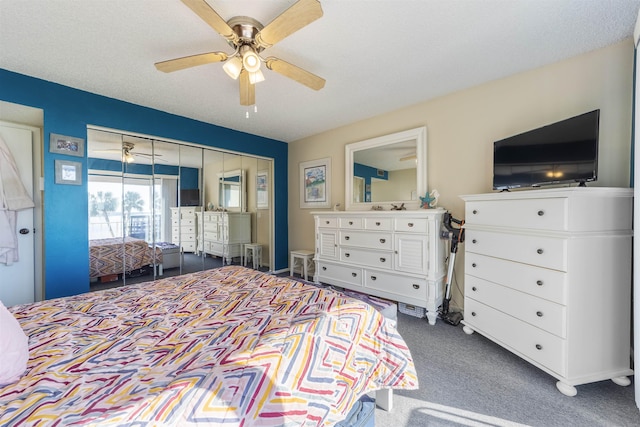 carpeted bedroom featuring a textured ceiling and ceiling fan