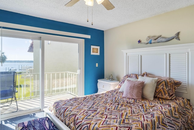 bedroom with ceiling fan, a textured ceiling, and access to outside