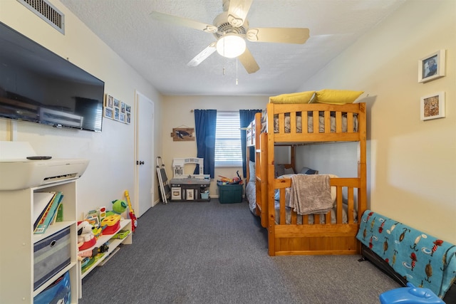 carpeted bedroom featuring a textured ceiling and ceiling fan