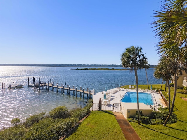 dock area featuring a lawn, a community pool, and a water view