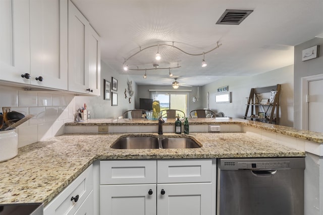 kitchen with ceiling fan, sink, rail lighting, stainless steel dishwasher, and white cabinets