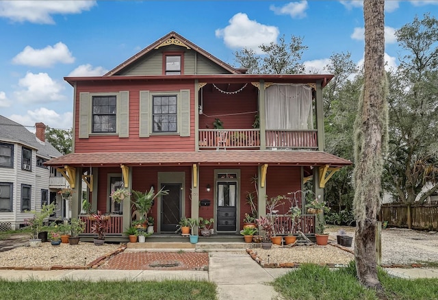 view of front of house with covered porch and a balcony