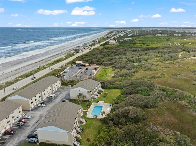 birds eye view of property featuring a water view and a beach view