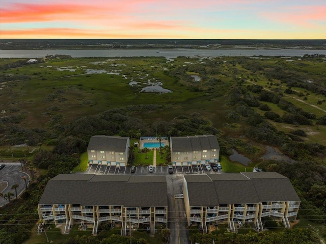 aerial view at dusk with a water view