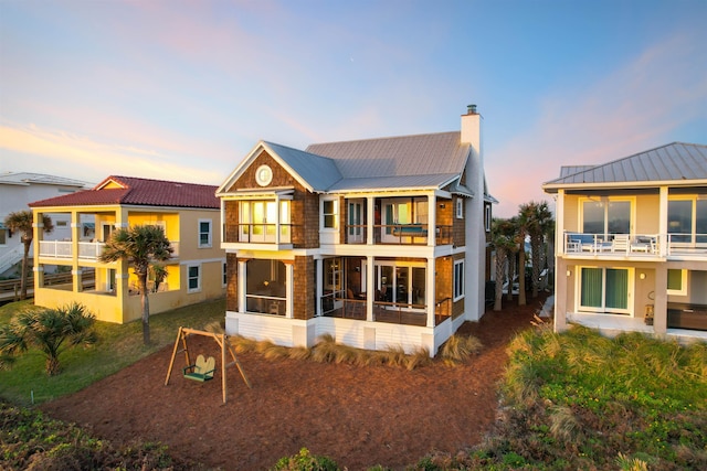 back house at dusk with a balcony