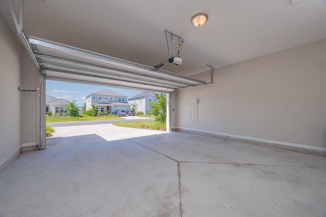 98 Windermere Way, Saint Augustine, FL 32095 - garage featuring a garage door opener, baseboards, and a residential view