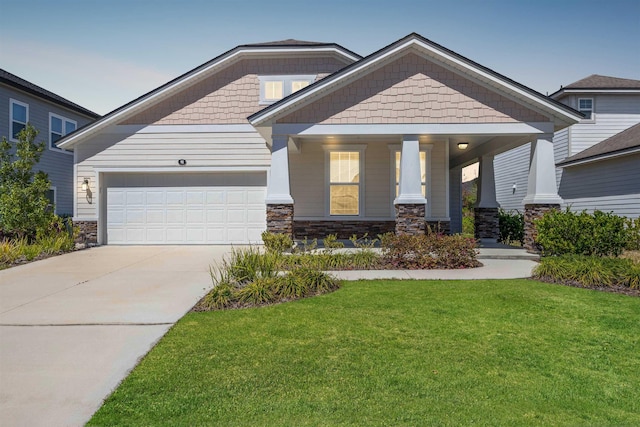 98 Windermere Way, Saint Augustine, FL 32095 - craftsman-style home featuring a front yard, concrete driveway, stone siding, and a garage