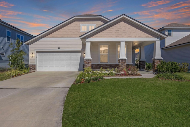 98 Windermere Way, Saint Augustine, FL 32095 - craftsman-style house featuring a front lawn, driveway, a garage, stone siding, and a porch