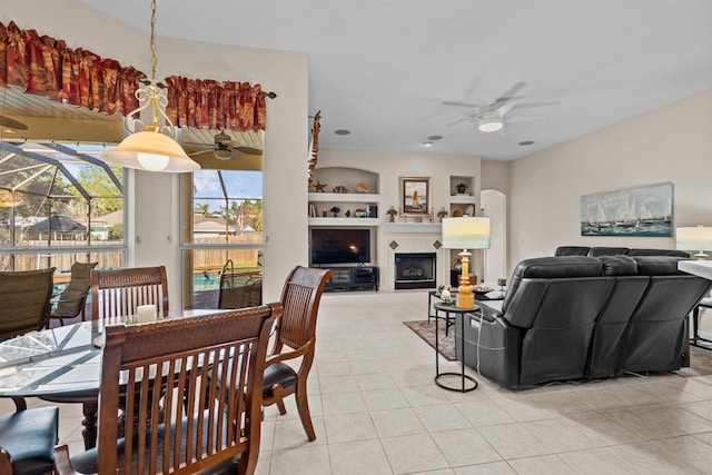 dining area featuring light tile patterned flooring, ceiling fan, and built in shelves