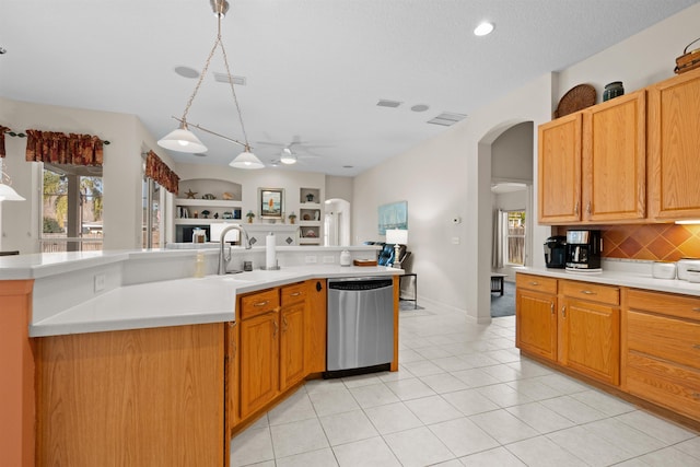 kitchen with built in shelves, sink, tasteful backsplash, decorative light fixtures, and dishwasher