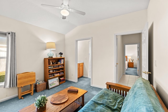 living room with vaulted ceiling, light colored carpet, and ceiling fan