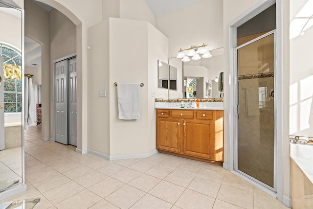 bathroom featuring walk in shower, tile patterned floors, and vanity