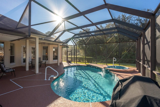 view of swimming pool featuring an in ground hot tub, pool water feature, a lanai, and a patio