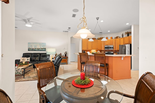 tiled dining space featuring ceiling fan