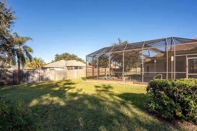 view of yard with glass enclosure