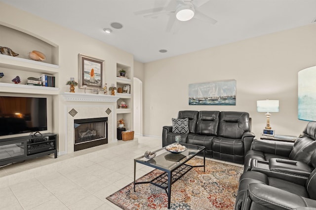 tiled living room with built in shelves and ceiling fan