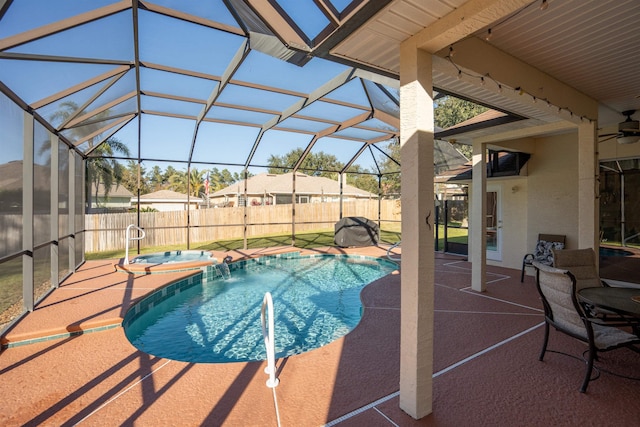 view of pool featuring an in ground hot tub, pool water feature, a patio area, and glass enclosure