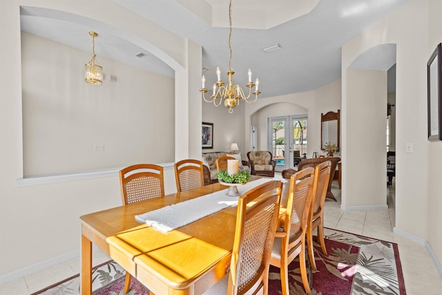 tiled dining area with an inviting chandelier and french doors