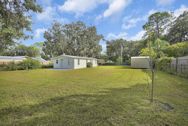 view of yard with a storage unit