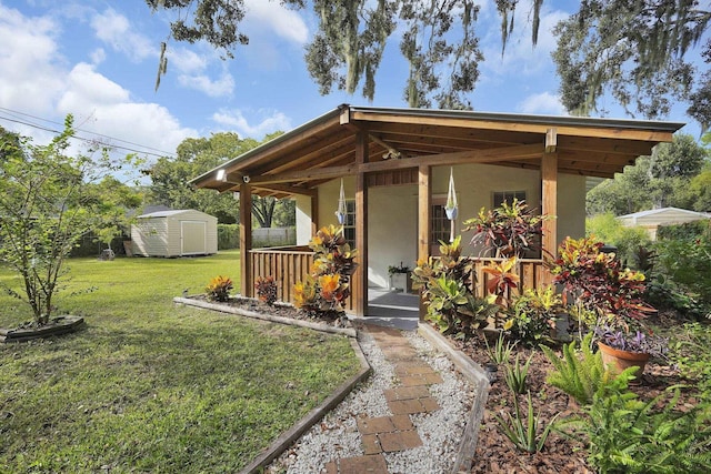 view of front of home with a front yard and a storage shed