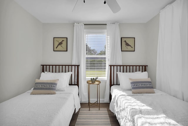 bedroom with ceiling fan and dark hardwood / wood-style flooring