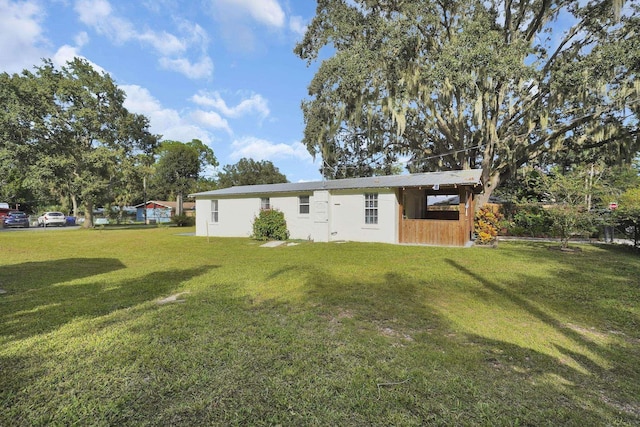 back of house with a lawn