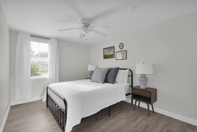 bedroom with hardwood / wood-style floors and ceiling fan