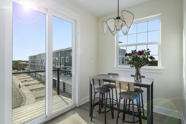 dining space featuring hardwood / wood-style flooring and a notable chandelier