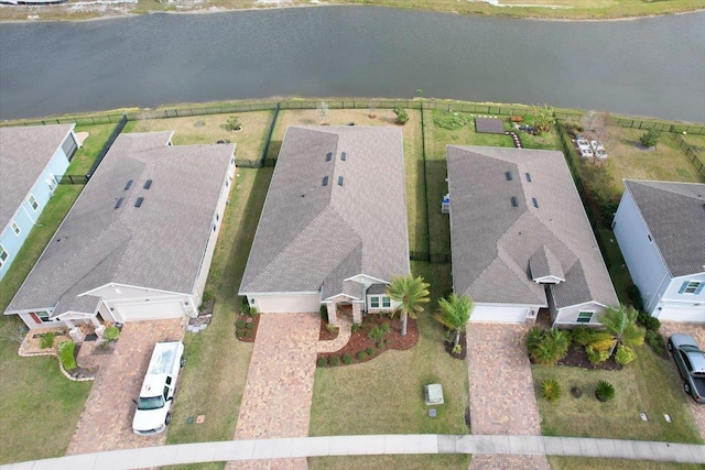 drone / aerial view with a water view and a residential view