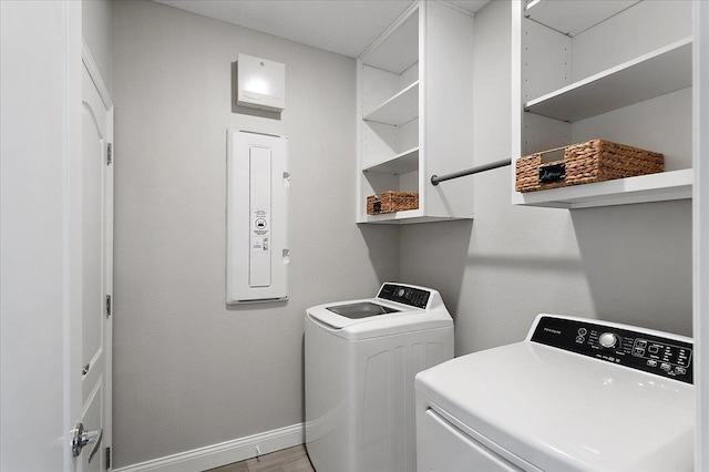 laundry area featuring laundry area, baseboards, light wood finished floors, and washing machine and clothes dryer