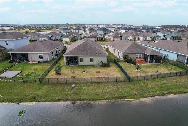 birds eye view of property with a residential view and a water view