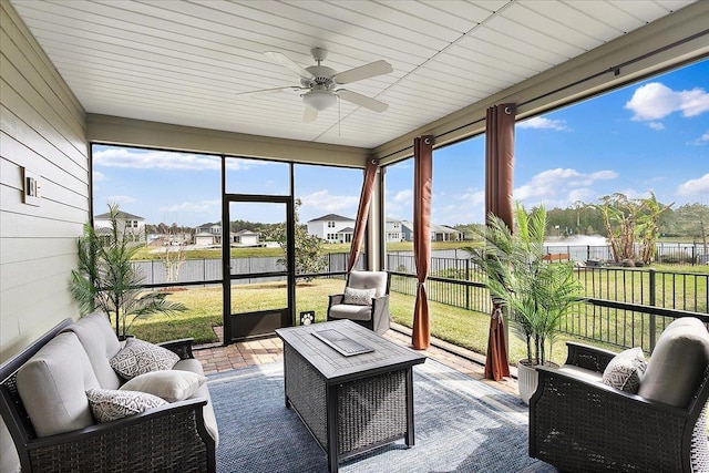 sunroom with a healthy amount of sunlight and ceiling fan