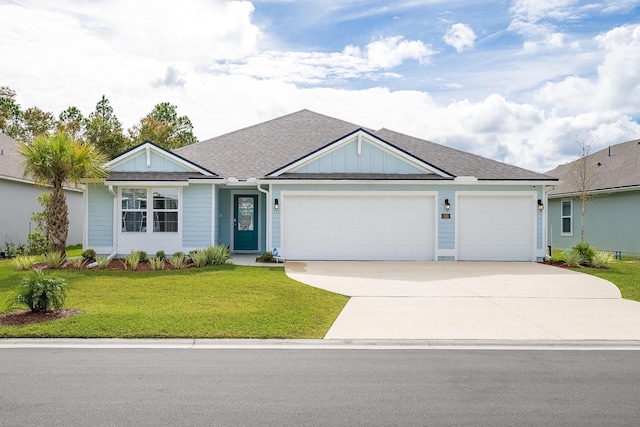 ranch-style house featuring an attached garage, a shingled roof, driveway, a front lawn, and board and batten siding