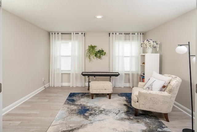 living area with light wood finished floors and baseboards