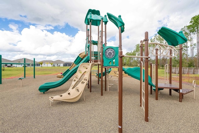 community jungle gym featuring a yard