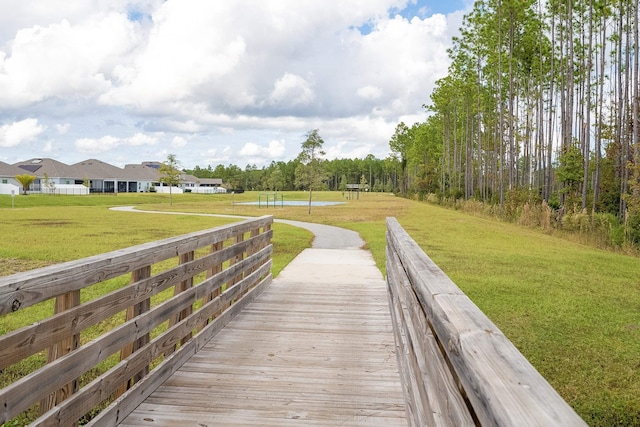 view of property's community with a residential view and a yard