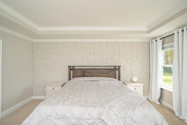 bedroom featuring a tray ceiling, light carpet, crown molding, and baseboards