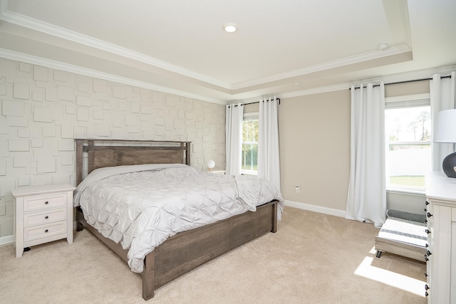 bedroom featuring baseboards, a raised ceiling, crown molding, and light colored carpet