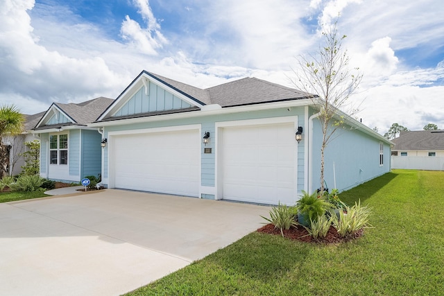 ranch-style house with a garage, driveway, roof with shingles, board and batten siding, and a front yard