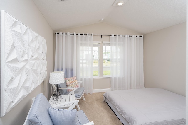 carpeted bedroom with vaulted ceiling