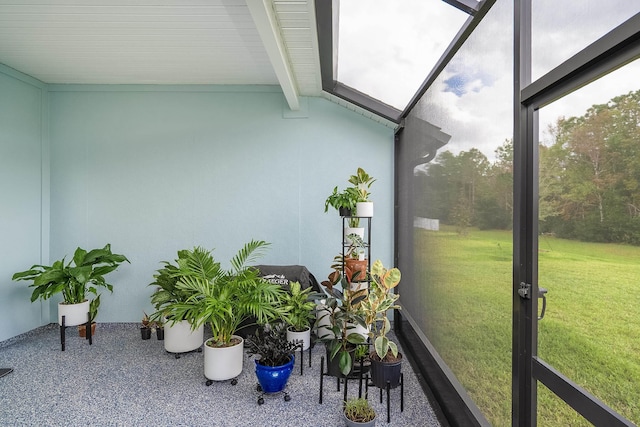 sunroom / solarium with a wealth of natural light and vaulted ceiling with beams