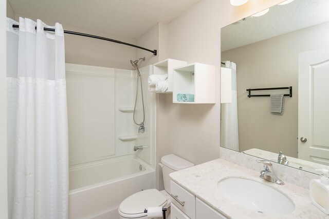 full bath featuring toilet, shower / bath combo, a textured ceiling, and vanity