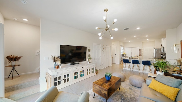 living room featuring light tile patterned flooring and a notable chandelier